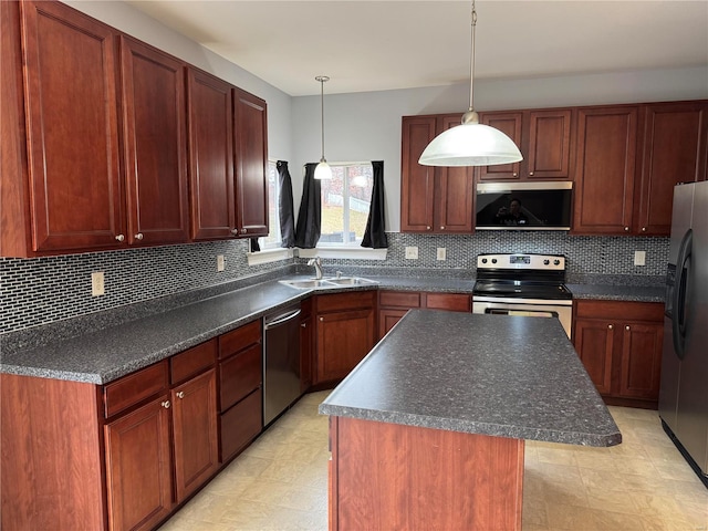 kitchen with sink, tasteful backsplash, appliances with stainless steel finishes, a kitchen island, and pendant lighting