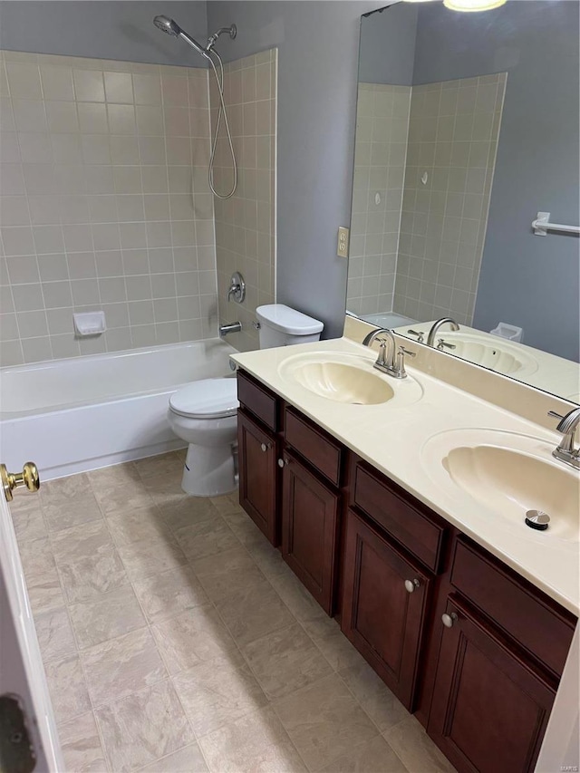 full bathroom with tiled shower / bath combo, vanity, and toilet