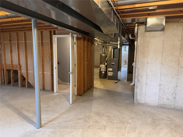 basement featuring heating unit and water heater