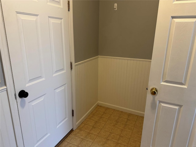 interior space with light floors and wainscoting