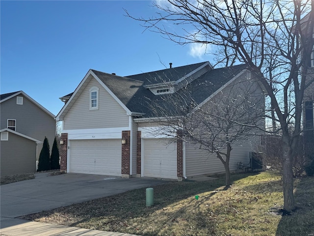 view of front of home with concrete driveway, brick siding, and roof with shingles