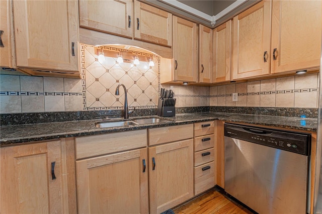 kitchen featuring tasteful backsplash, dishwasher, a sink, and light brown cabinetry