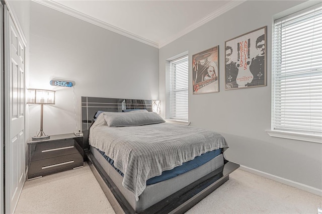 bedroom with carpet floors, baseboards, and ornamental molding