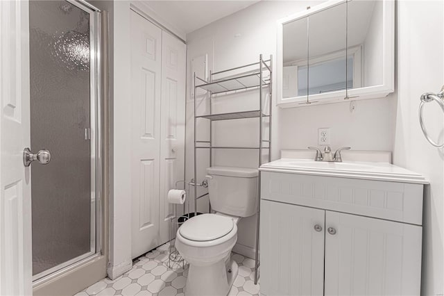 full bathroom featuring a stall shower, vanity, toilet, and tile patterned floors