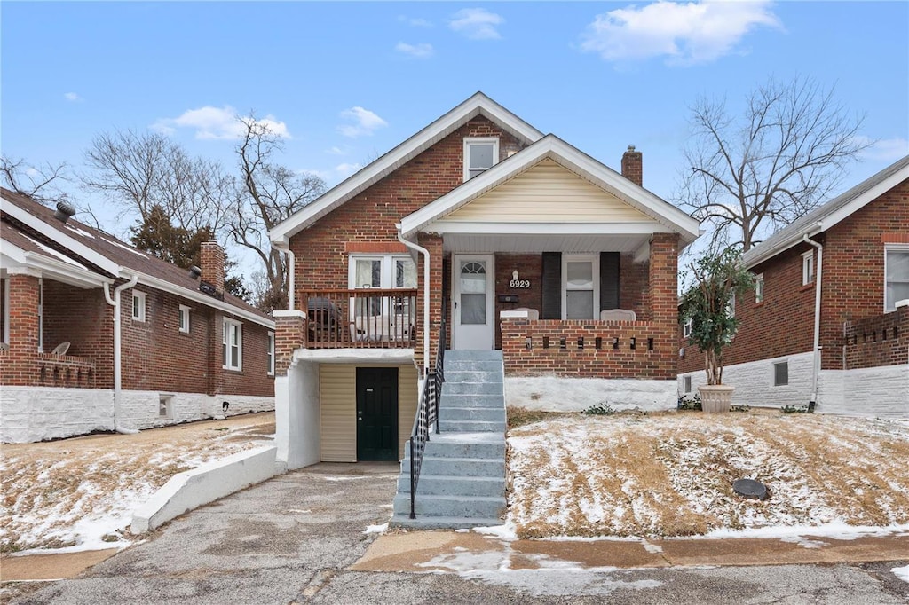 bungalow with covered porch and a carport