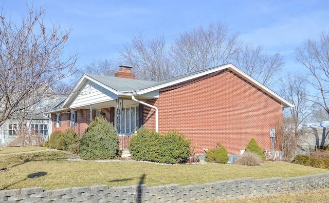 view of side of home featuring a yard