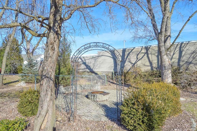 view of yard featuring a fire pit and a patio area