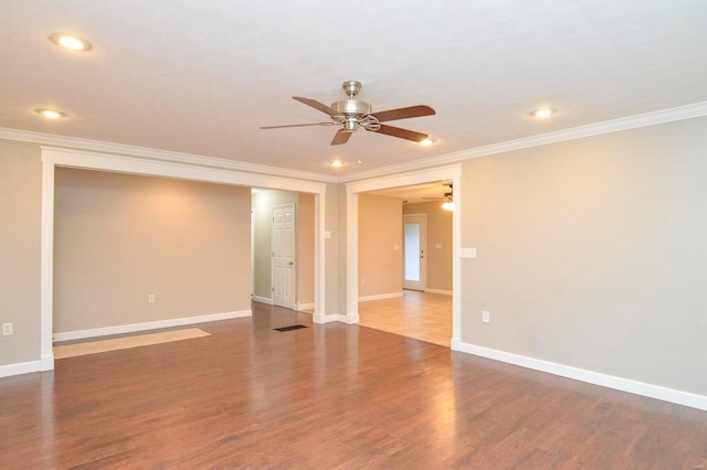 empty room with crown molding, dark wood-type flooring, and ceiling fan