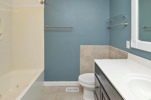 bathroom featuring vanity, tile patterned floors, and toilet