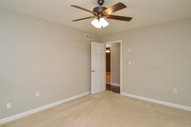 carpeted spare room with ceiling fan