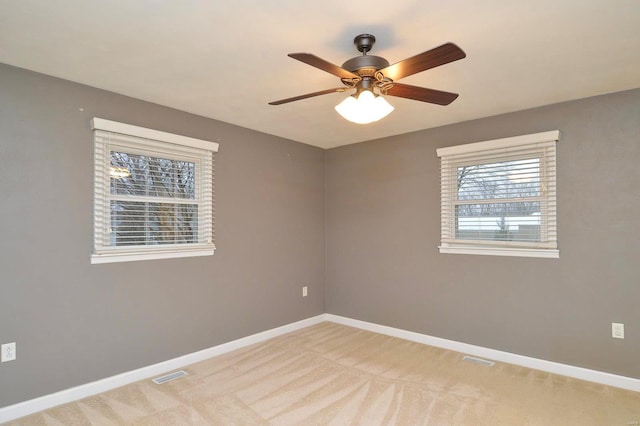 carpeted empty room featuring ceiling fan