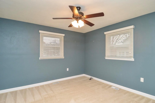 carpeted empty room featuring ceiling fan