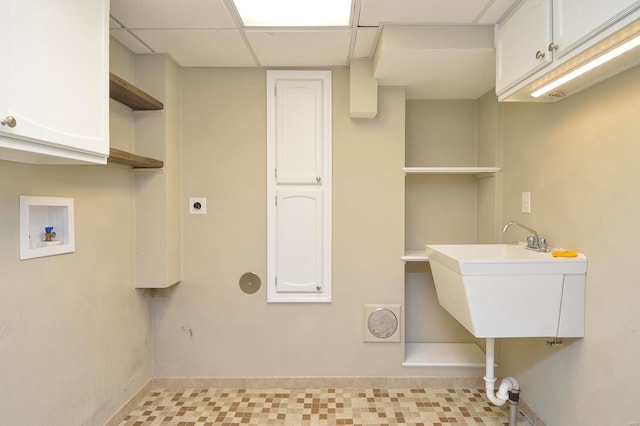 washroom with cabinets, electric dryer hookup, sink, and washer hookup