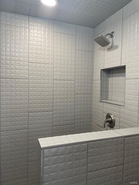 bathroom with a tile shower