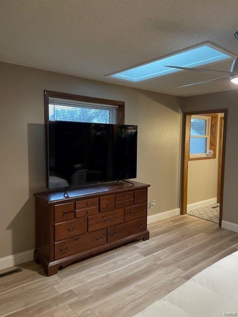 living room with light hardwood / wood-style flooring and a textured ceiling