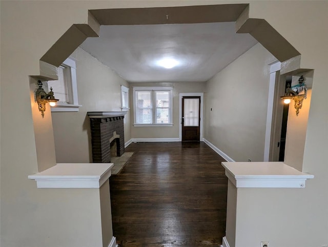 entrance foyer featuring a fireplace and dark hardwood / wood-style flooring