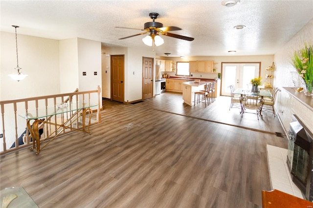 living room with dark hardwood / wood-style floors and a textured ceiling