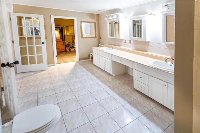 bathroom with tile patterned flooring, vanity, and toilet