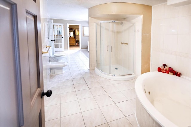 bathroom featuring tile patterned floors, toilet, tile walls, a bidet, and plus walk in shower