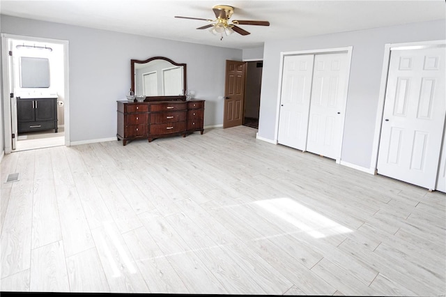 bedroom with ceiling fan, connected bathroom, light wood-type flooring, and a closet