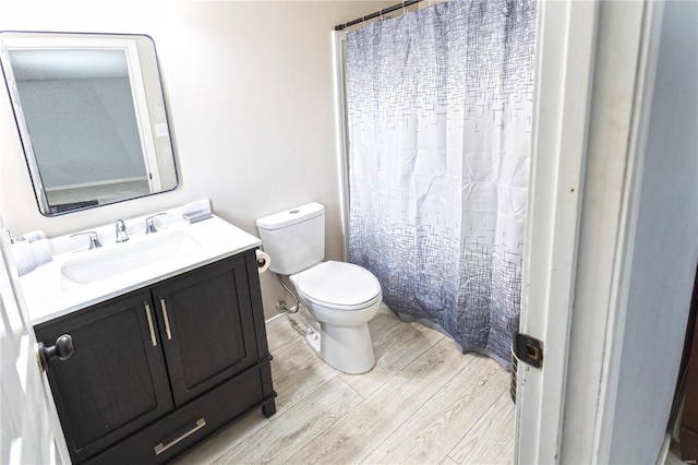 bathroom featuring hardwood / wood-style flooring, vanity, and toilet