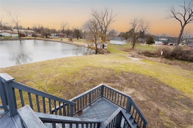 yard at dusk with a water view