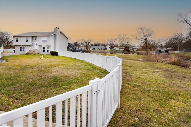 view of yard at dusk