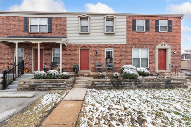 townhome / multi-family property featuring brick siding