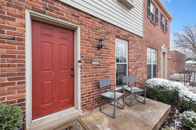 property entrance with brick siding