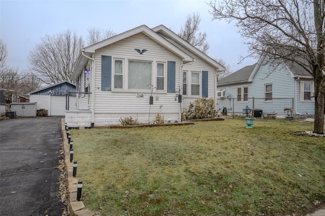 bungalow-style house with a front lawn