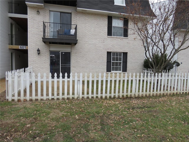 view of side of property with a lawn