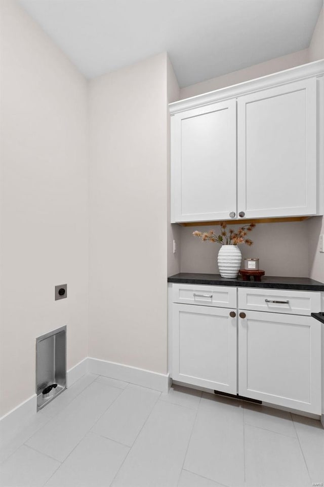 washroom featuring laundry area, hookup for an electric dryer, baseboards, and light tile patterned floors