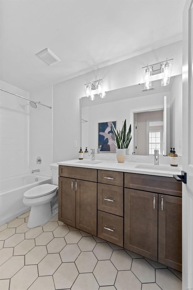 full bath featuring washtub / shower combination, double vanity, a sink, and toilet