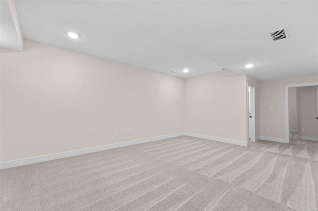 basement featuring light carpet, recessed lighting, visible vents, and baseboards