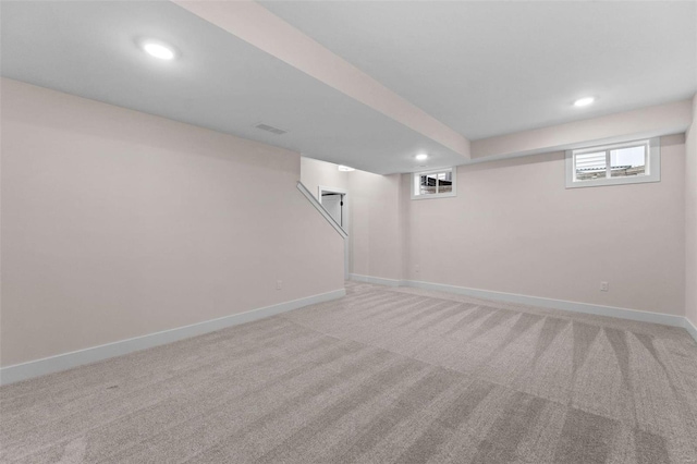 basement featuring recessed lighting, light colored carpet, and baseboards