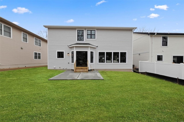 back of property featuring entry steps, a yard, a patio, and fence