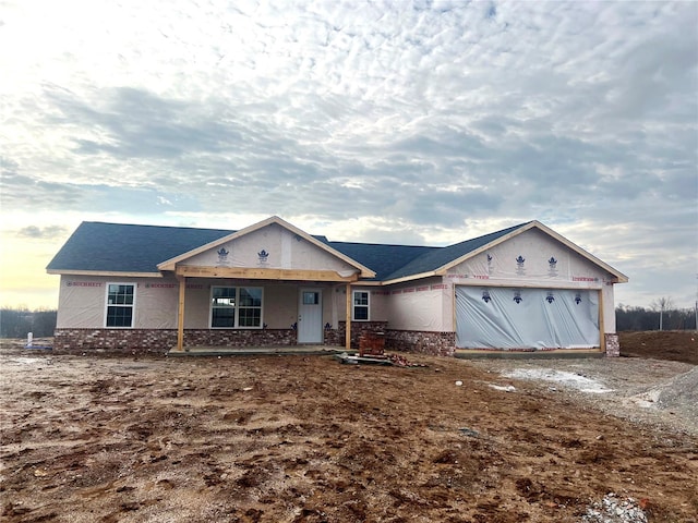 view of front of house featuring an attached garage and brick siding