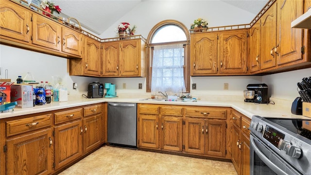 kitchen featuring appliances with stainless steel finishes, sink, and lofted ceiling