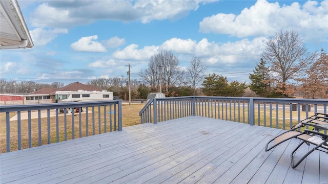 wooden deck with a lawn