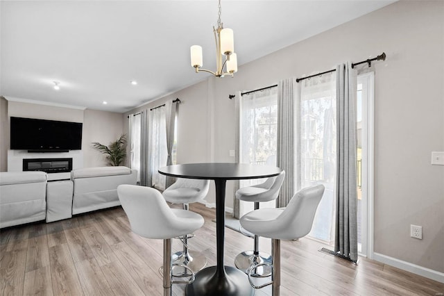 dining room featuring wood finished floors, visible vents, baseboards, recessed lighting, and a notable chandelier