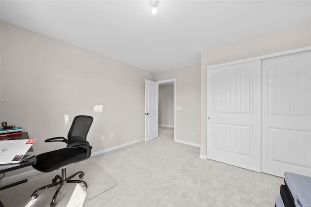 office area featuring light colored carpet and baseboards