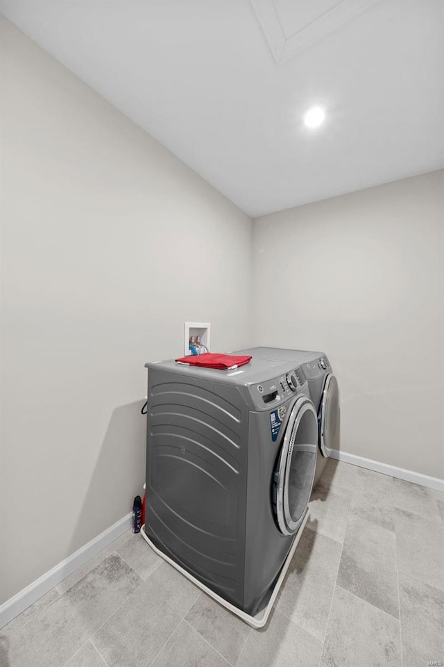 laundry room featuring laundry area, baseboards, and washer and clothes dryer