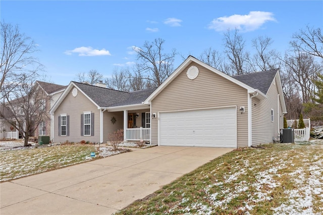 ranch-style house with a garage, central AC unit, a porch, and concrete driveway