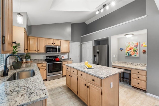 kitchen with light brown cabinets, a sink, a kitchen island, stainless steel appliances, and light stone countertops