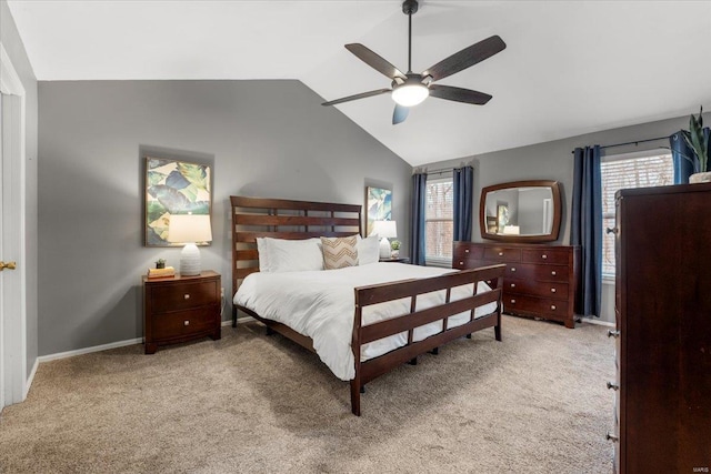 carpeted bedroom featuring lofted ceiling, multiple windows, a ceiling fan, and baseboards