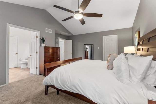 bedroom with visible vents, vaulted ceiling, carpet floors, ensuite bath, and a ceiling fan