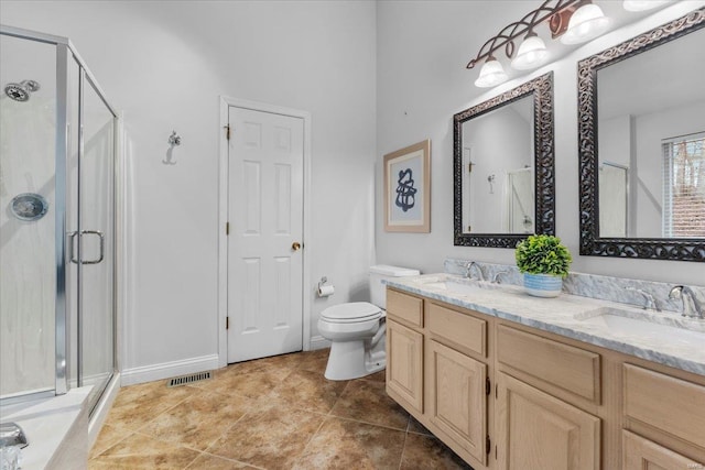 bathroom featuring a sink, visible vents, double vanity, and a shower stall