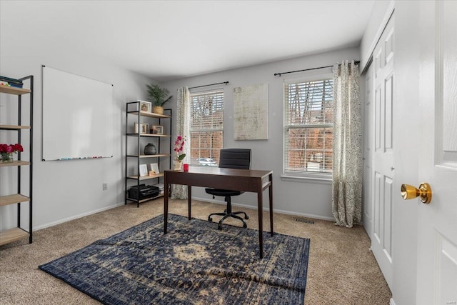 office area with visible vents, baseboards, and carpet