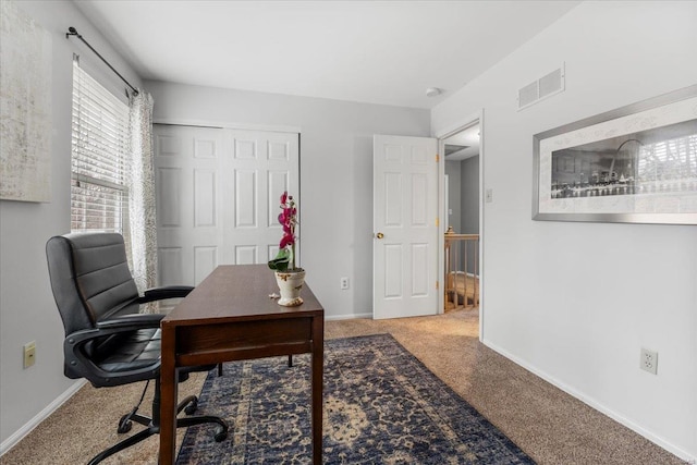 carpeted home office with visible vents and baseboards