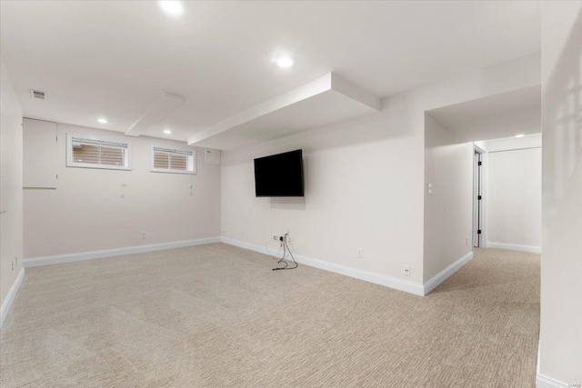 finished below grade area featuring recessed lighting, visible vents, and light carpet